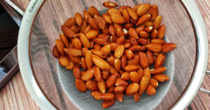 Soaked almonds after being rinsed in a fine mesh strainer.