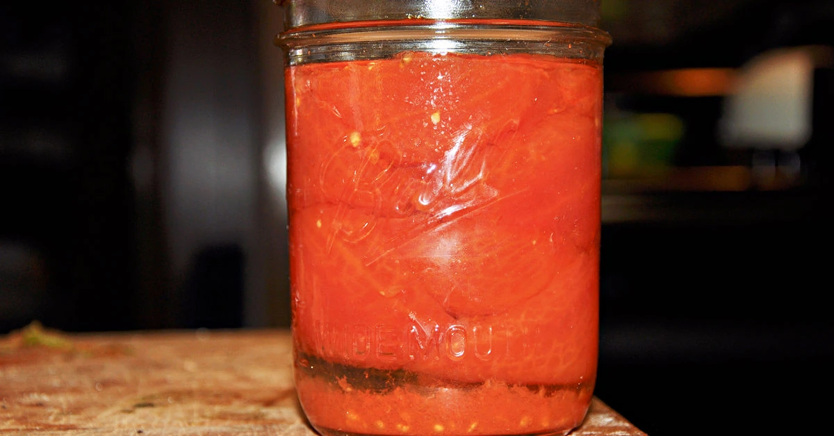 Pint jar of home canned tomatoes from the garden.