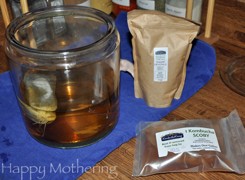 Tea brewing in glass jar on counter.