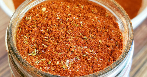 Close up of paprika chicken seasoning blend in a mason jar.