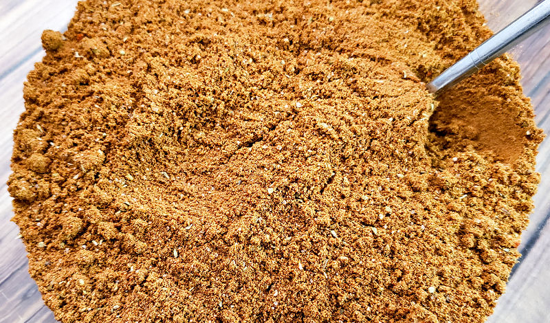 Taco seasoning being mixed in a bowl.