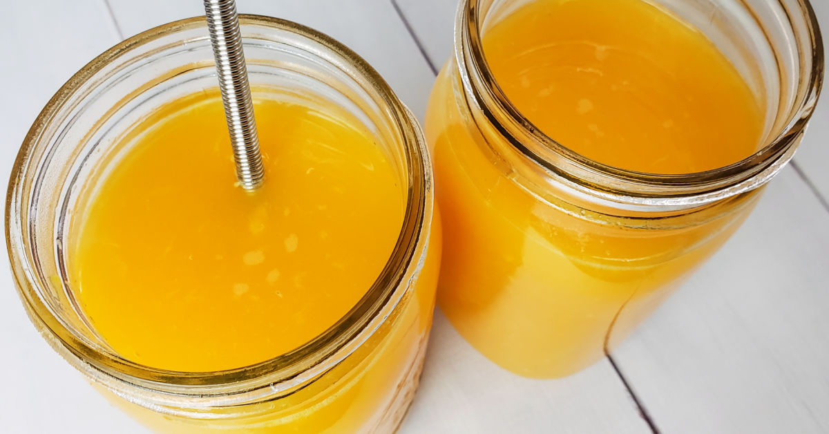 Orange juice, water and culture starter being whisked together in mason jar.