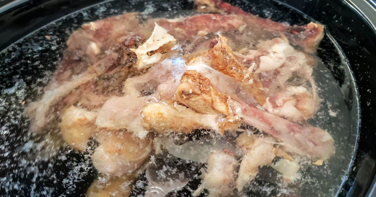 Chicken bones, water, apple cider vinegar and sea salt in slow cooker.