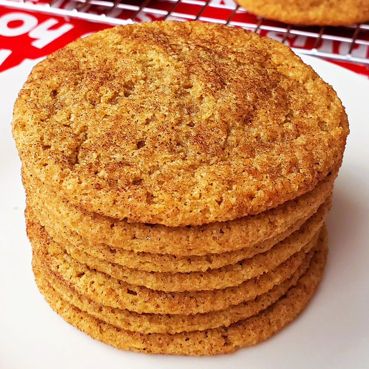 Gluten free snickerdoodles stacked on a white plate