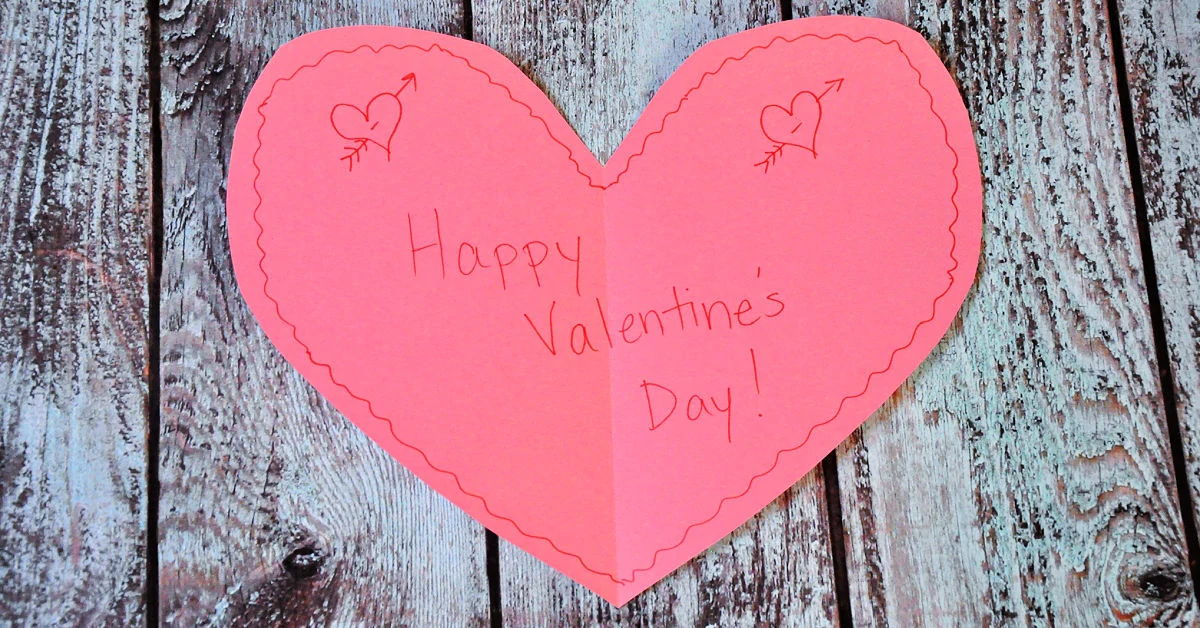 Happy Valentine's Day written on a pink construction paper heart