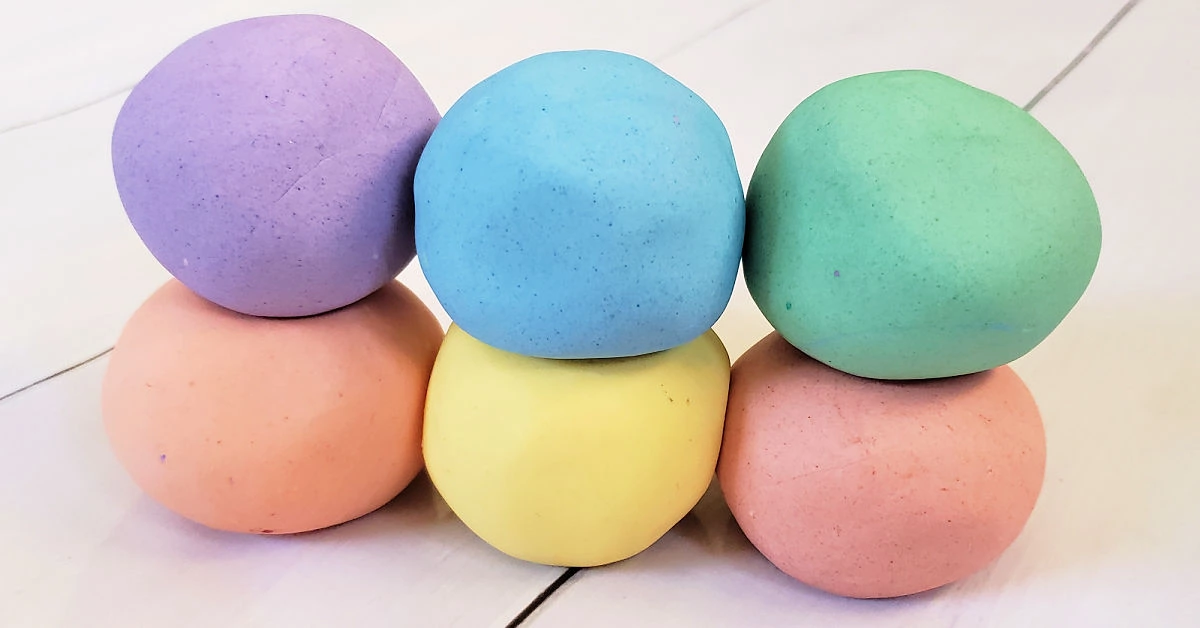 Cloud dough in 6 colors: purple, orange, blue, yellow, green and red.