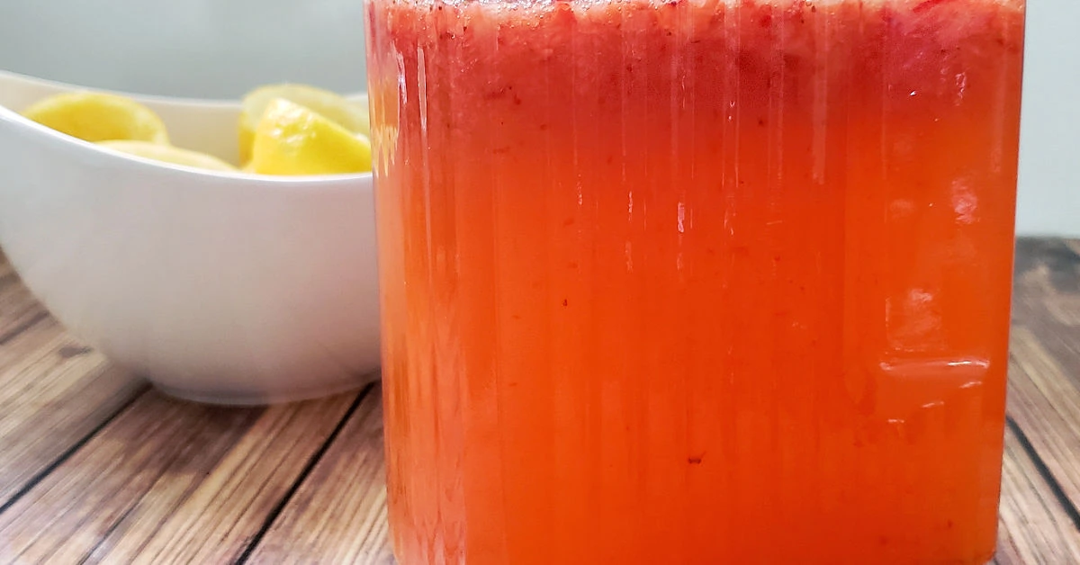 Strawberry lemonade concentrate in pitcher.