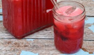 Close up of pint sized mason jar full of homemade cherry limeade