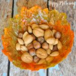 Overhead view of fall leaves bowl with nuts in it