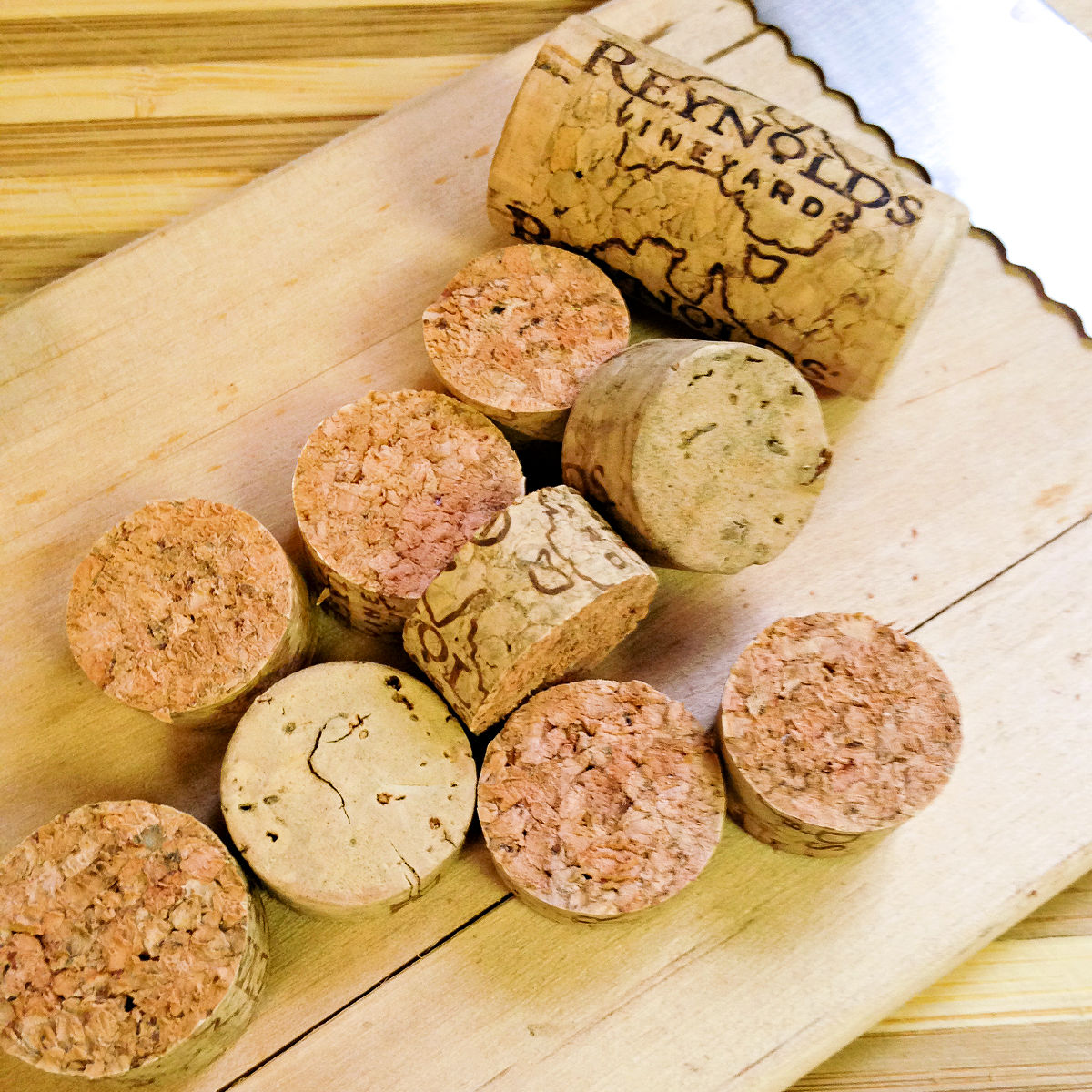 Cut up wine corks on a cutting board with a serrated knife