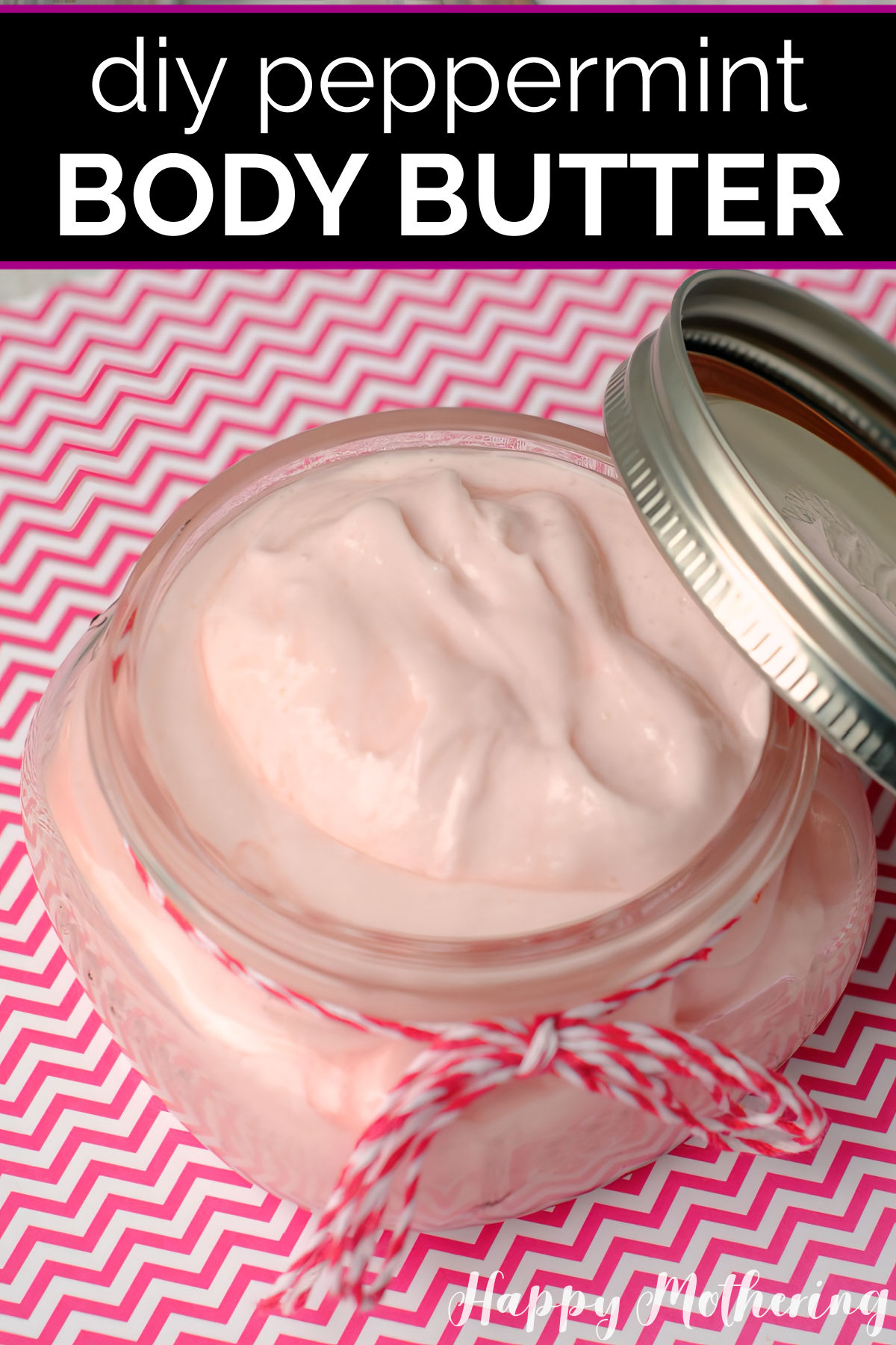 Half pint mason jar of pink DIY Peppermint Body Butter on a pink and white chevron paper