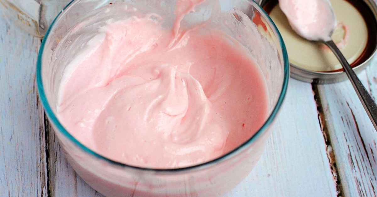 Pink peppermint body butter whipped in a glass bowl.