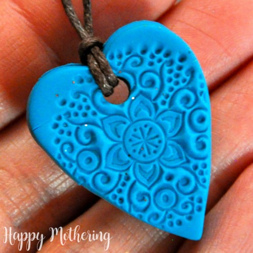 Close up of homemade polymer clay essential oil diffuser necklace