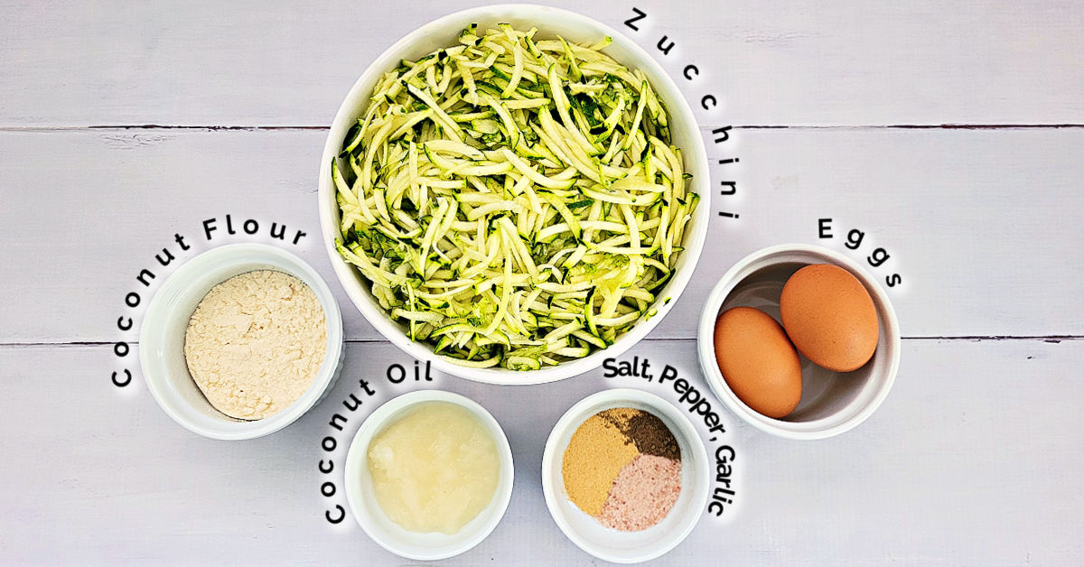 Zucchini fritter ingredients, including shredded zucchini, coconut flour, coconut oil, eggs, salt, pepper and garlic.
