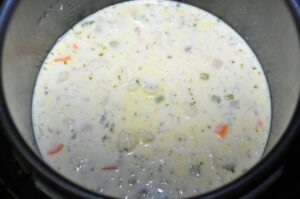 Chunks of cooked veggies in cauliflower soup that will need to be broken down or pureed