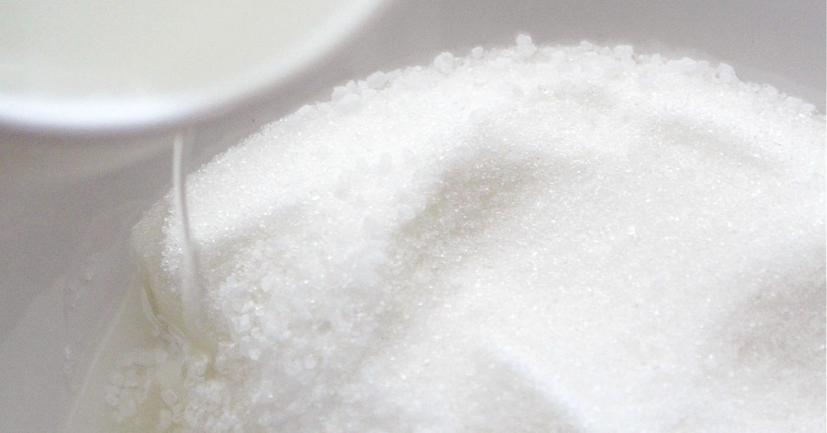 Combining sugar and oil in a mixing bowl
