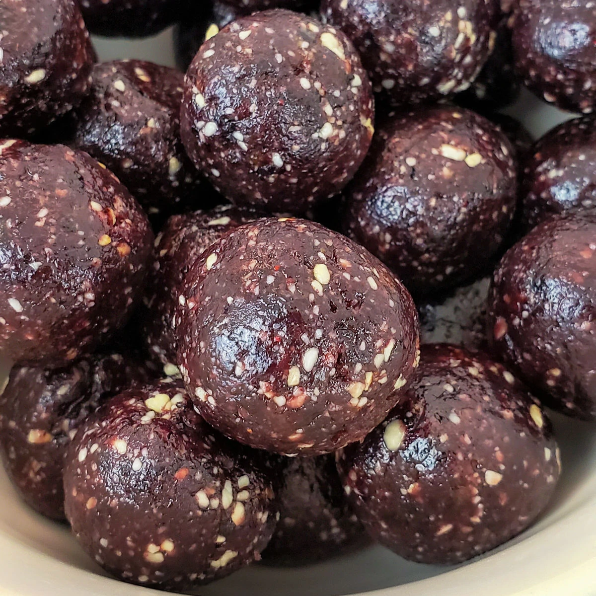 Close up of Blueberry Cashew Date Energy Balls in a bowl.
