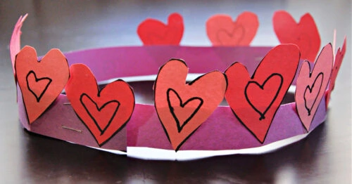 Close up of heart crown made from construction paper for Valentine's Day school craft.