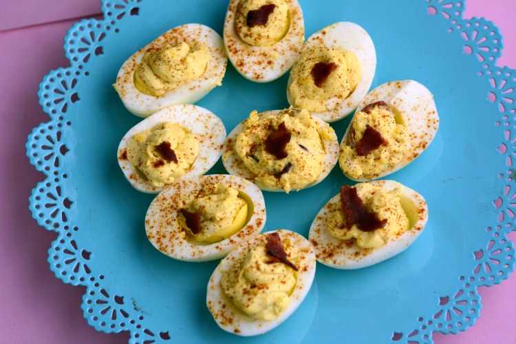 Deviled eggs on a blue mat from overhead