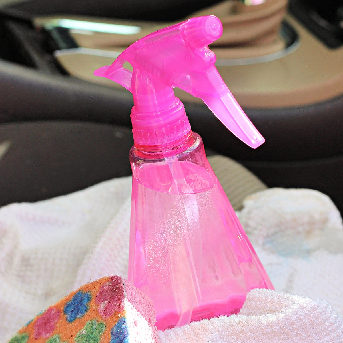 Pink spray bottle of homemade upholstery cleaner