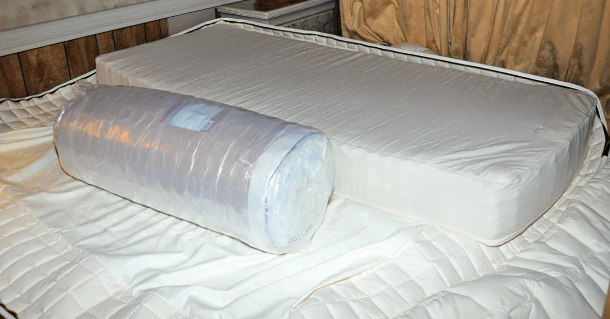 Naturepedic EOS mattress microcoil layers being placed into mattress encasement.