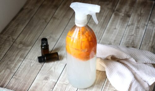 All purpose cleaner on table with towel and essential oils