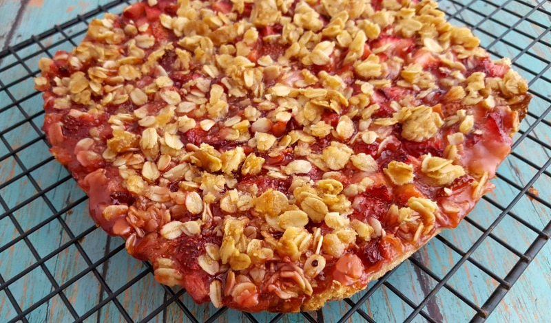 Gluten free strawberry oatmeal bars cooling on a rack before being cut