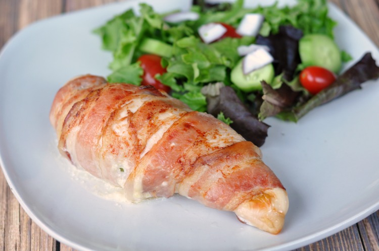 Jalapeno Popper Stuffed Chicken breast on a white plate with a green salad