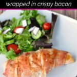 White dinner plate with bacon wrapped jalapeno popper chicken breast and dinner salad