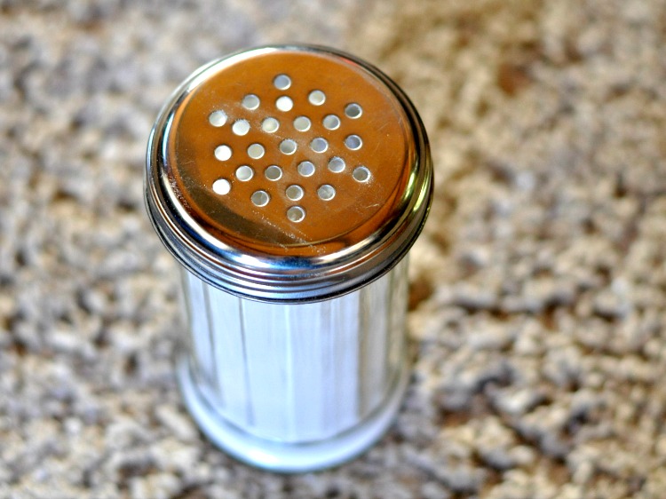 Shaker jar of carpet deodorizer on tan carpet