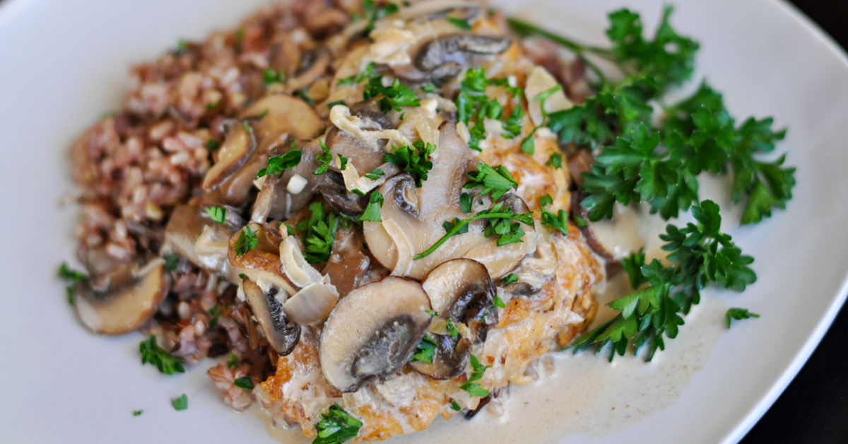 Creamy chicken marsala served with wild rice and garnished with fresh parsley.