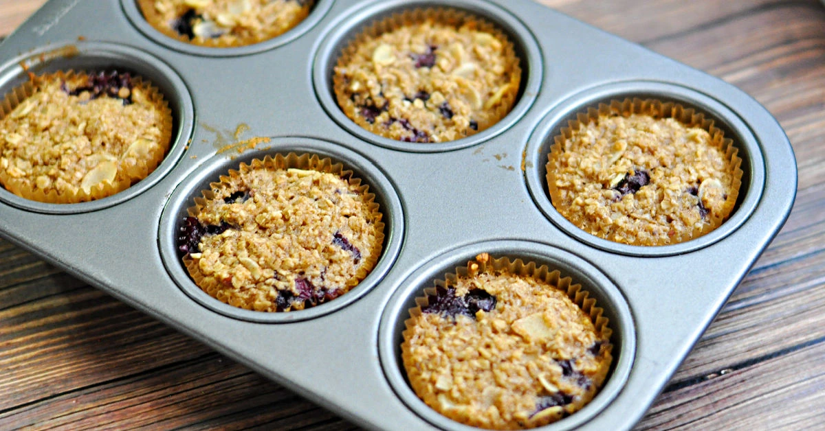 Baked blueberry oatmeal muffins cooling in the pan.