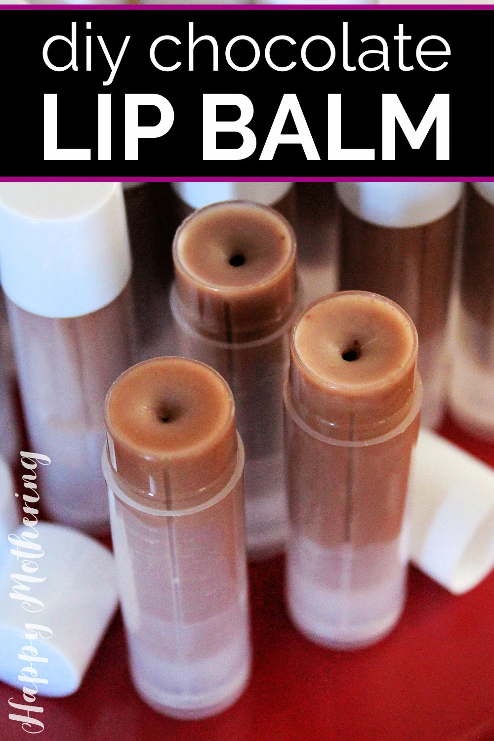 Several tubes of DIY Chocolate Lip Balm on a red tray.