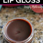 Homemade chocolate lip gloss on a granite counter next to a woman's blue purse