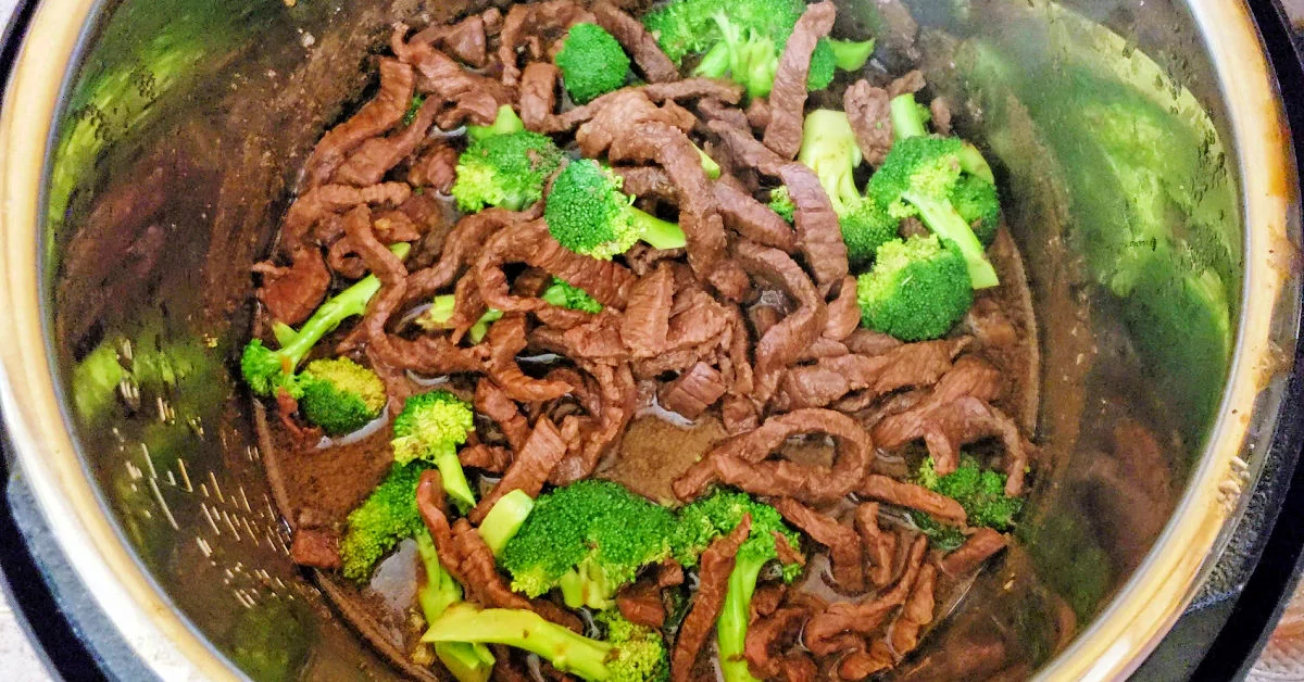 Chopped broccoli added to Mongolian Beef in Instant Pot and stirred together