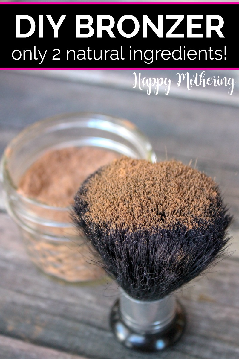 Large makeup brush dipped in DIY bronzer that is stored in a jelly jar set on a wood table