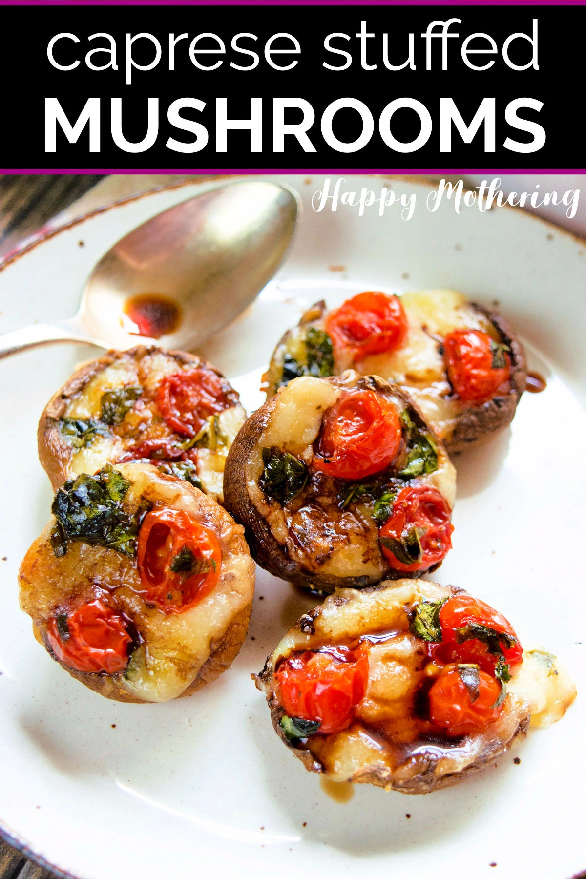 Five caprese stuffed mushrooms on a white plate with brown edge.