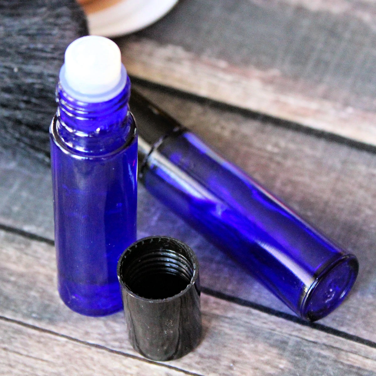 2 blue roller bottles of homemade lip gloss