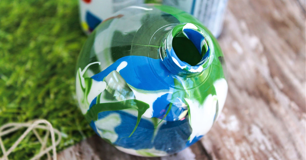 Blue, white and green paint in clear fillable ornament.
