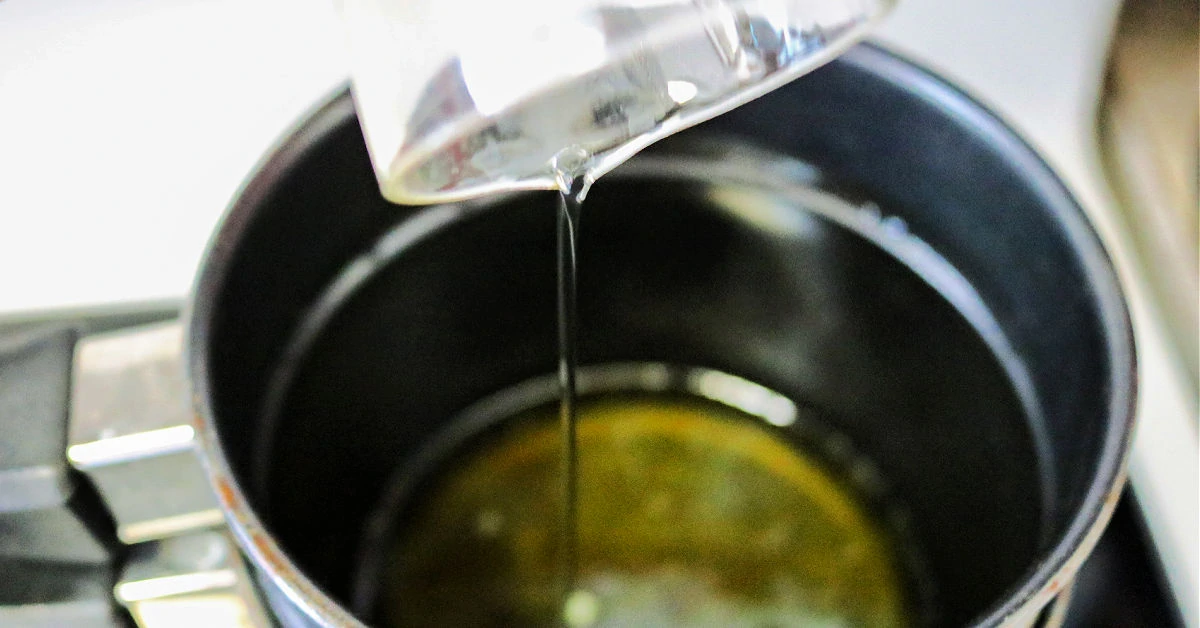 Adding oil to pan with beeswax