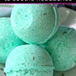 Four green bath bombs stacked in a white ceramic bowl