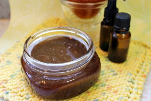 Squat mason jar of homemade exfoliating brown sugar and honey facial mask