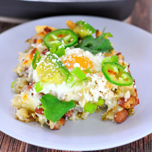 Close up of piece of Chicken Verde Chilaquiles casserole topped with jalapeno slices on a plate