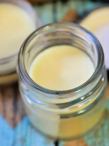 Open jar of homemade balm fore sore muscles.