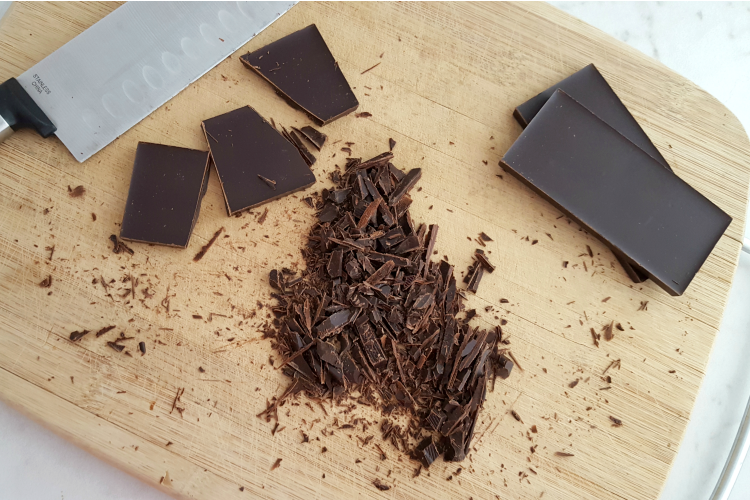 Chocolate bar chopped on a cutting board