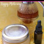 Sealed jar of homemade honey face mask on a knit yellow cloth next to a bottle of essential oil and a jar of honey