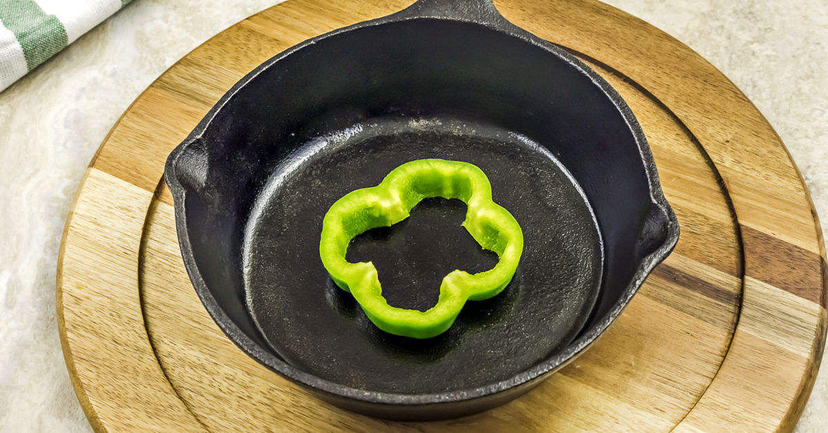Bell pepper slice in a cast iron frying pan.