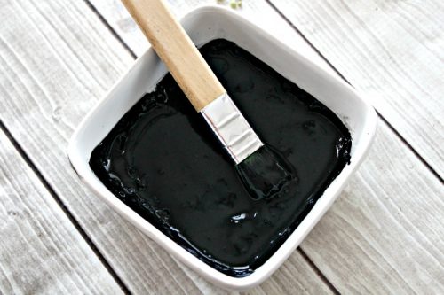 Activated charcoal tightening mask in white bowl
