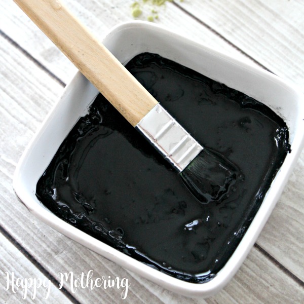 White square bowl of activated charcoal face mask for tight skin