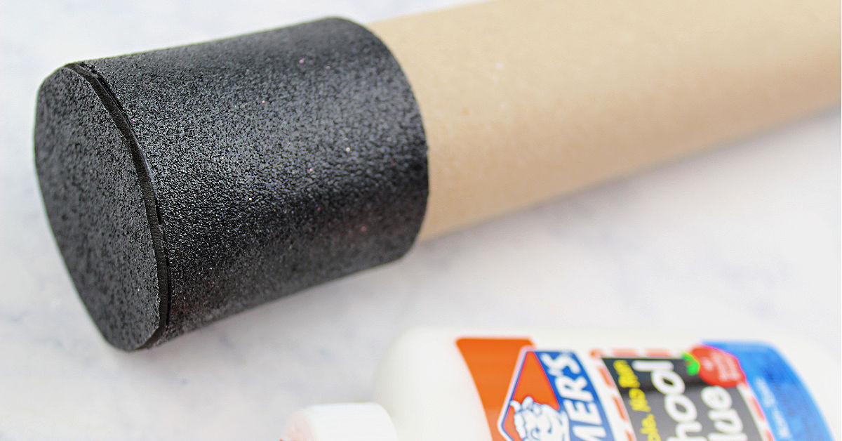 Black foam glued over end of toilet paper tube.